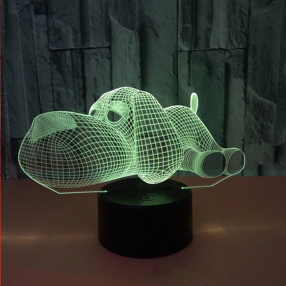 Doggo shaped 3D illusion desktop lamp glowing in multiple colours on a desk.