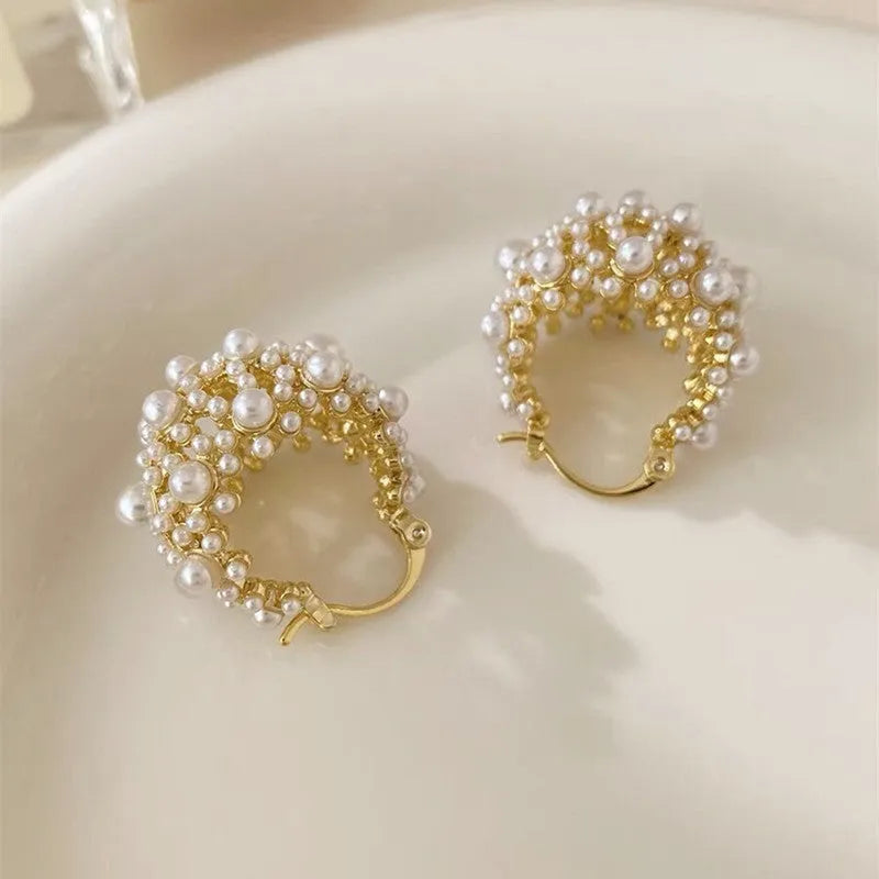 Women's copper flower basket earrings with small rice-shaped beads in gold finish, approximately 3-4 cm diameter