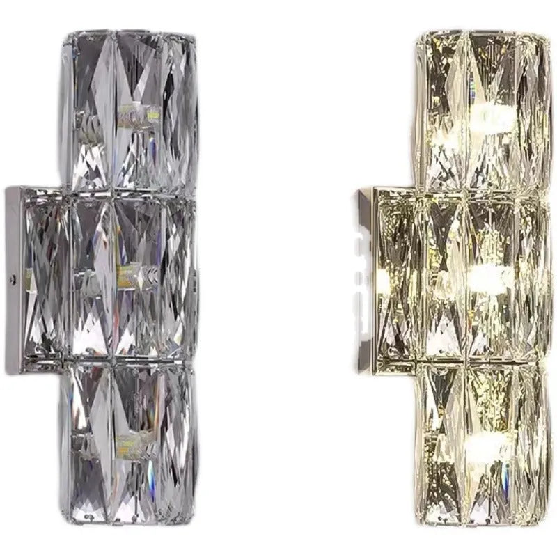 A sleek crystal wall lamp with a stainless steel base in chrome finish, mounted on a wall.