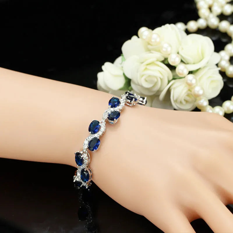 Copper-plated gold bracelet with geometric design and AAA+ zircon stones in five colour options on 18.4cm adjustable band