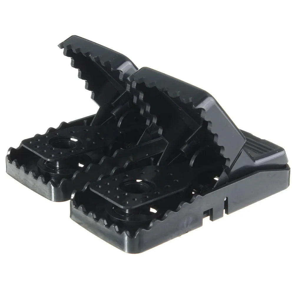 Six black plastic snap mousetraps showing smooth surface and compact size