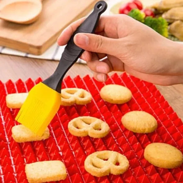 Red silicone pyramid cooking mat with grid pattern for oven and BBQ use