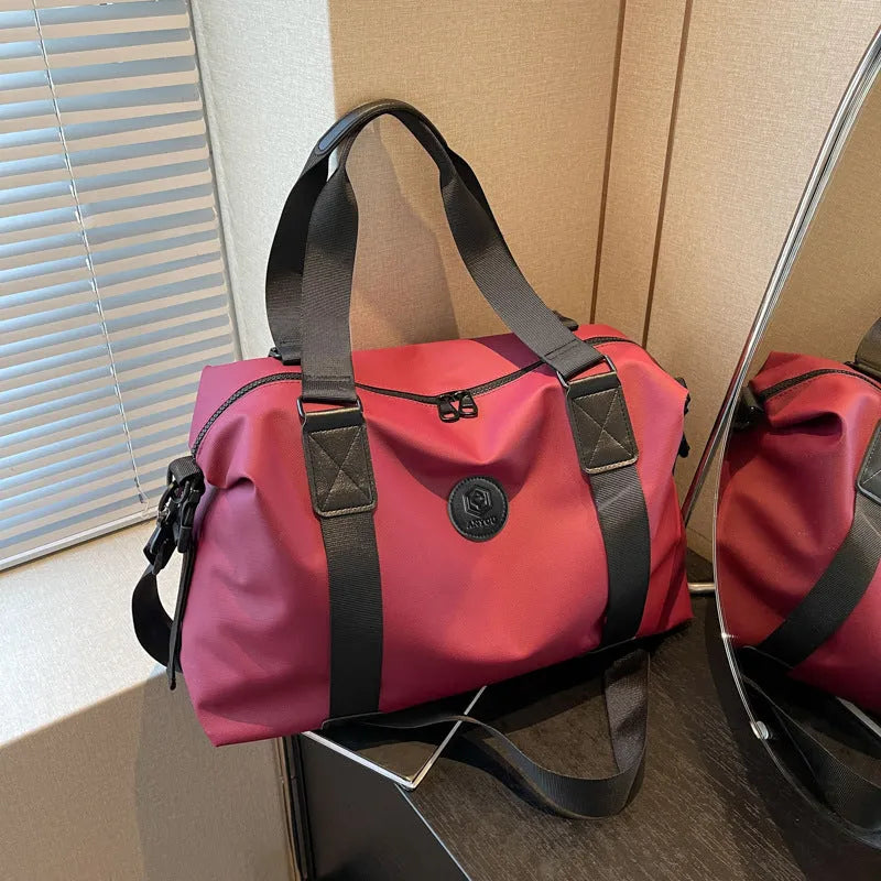 Large black waterproof Oxford cloth travel rucksack with multiple compartments shown on a grey background.