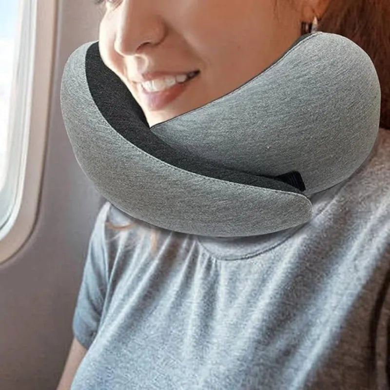 Navy blue U-shaped travel neck pillow with memory foam filling shown rolled and in its carry bag