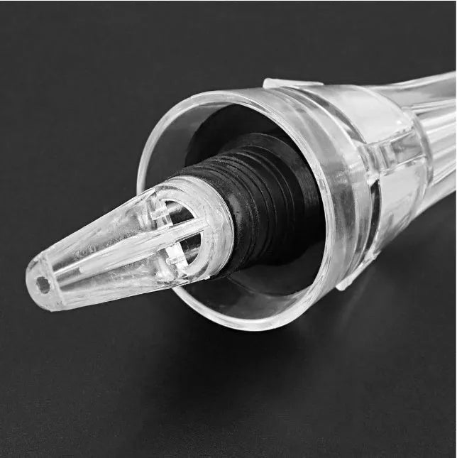 Wine aerator with stainless steel filter, measuring 16cm in length and 4.2cm in diameter, on a glass with red wine.