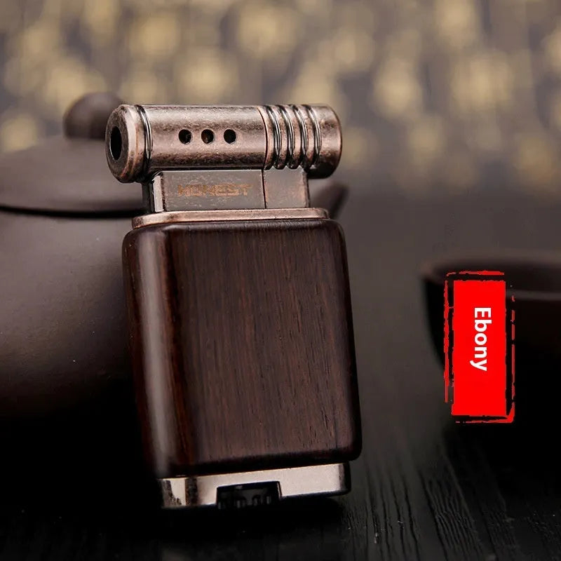 Ebony gas lighter with black wood body and rosewood decorative accents including sun surface and good luck designs