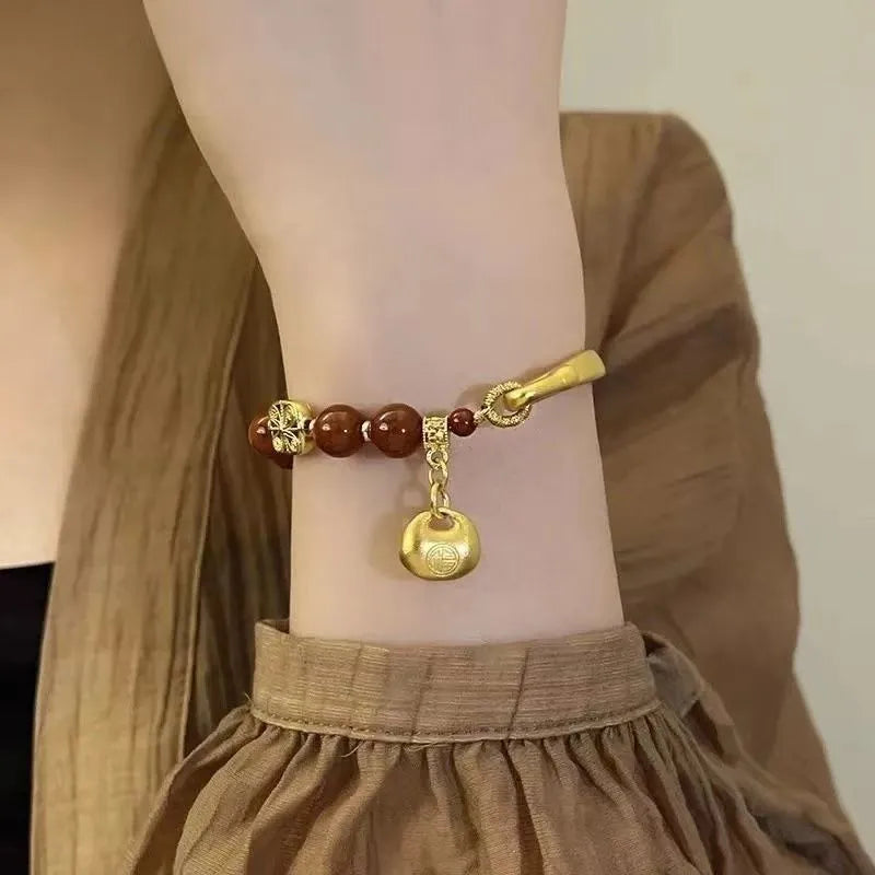 Golden Southern Red Agate character ingot bracelet with antique design on wrist