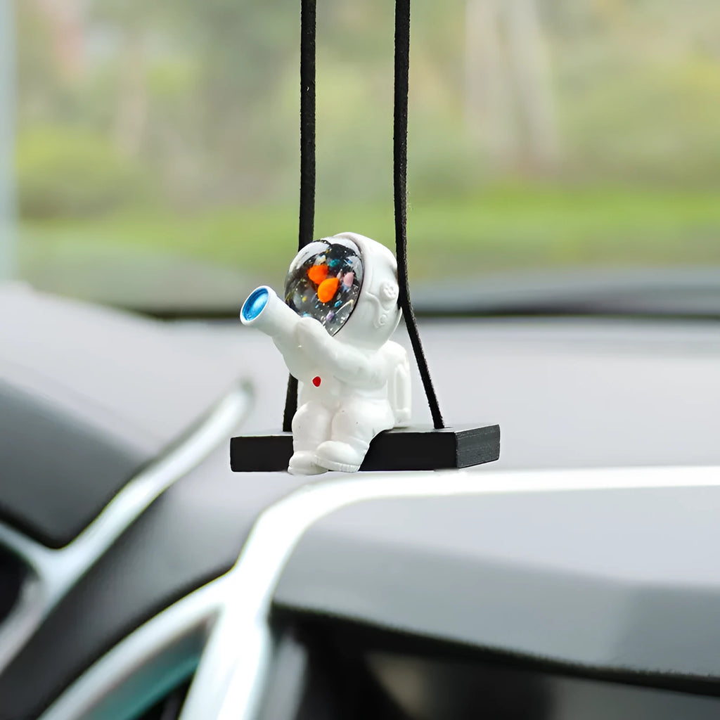 Resin cartoon astronaut car pendant hanging from a rear-view mirror.