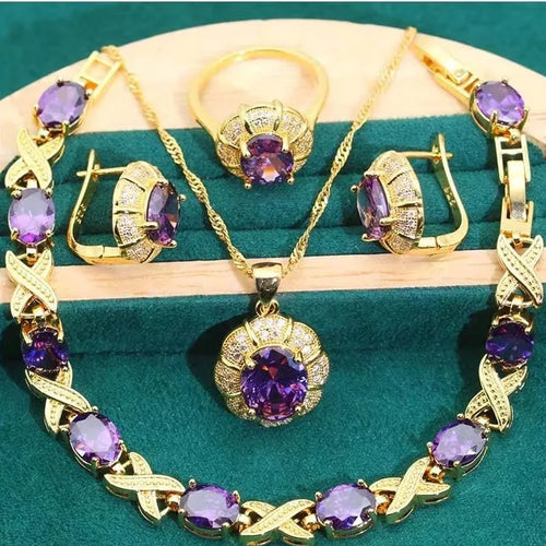 18k gold plated four-piece jewellery set with synthetic cubic zirconia stones in Raytheon cut, showing necklace, earrings, ring, and bracelet