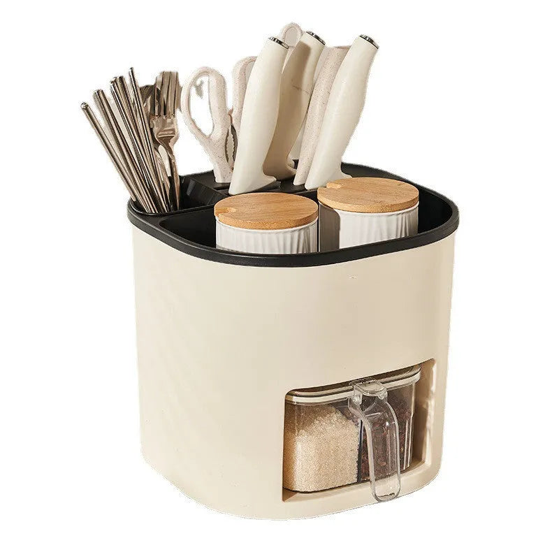 White rotating kitchen storage bucket with utensils next to a four-compartment spice box on a countertop.
