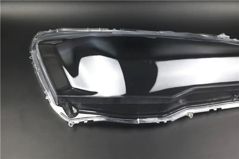 Transparent plastic automotive headlight housing cover showing clear construction