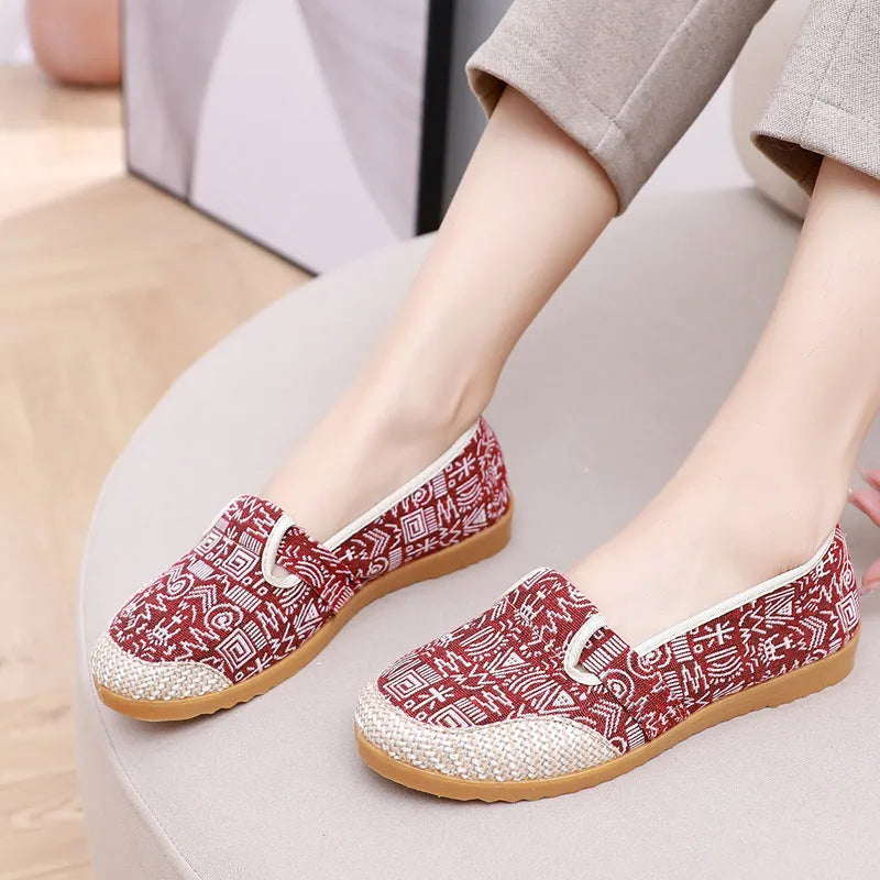 Women's ethnic style cloth shoes with flat heel, colour stitching, and a shallow mouth design.