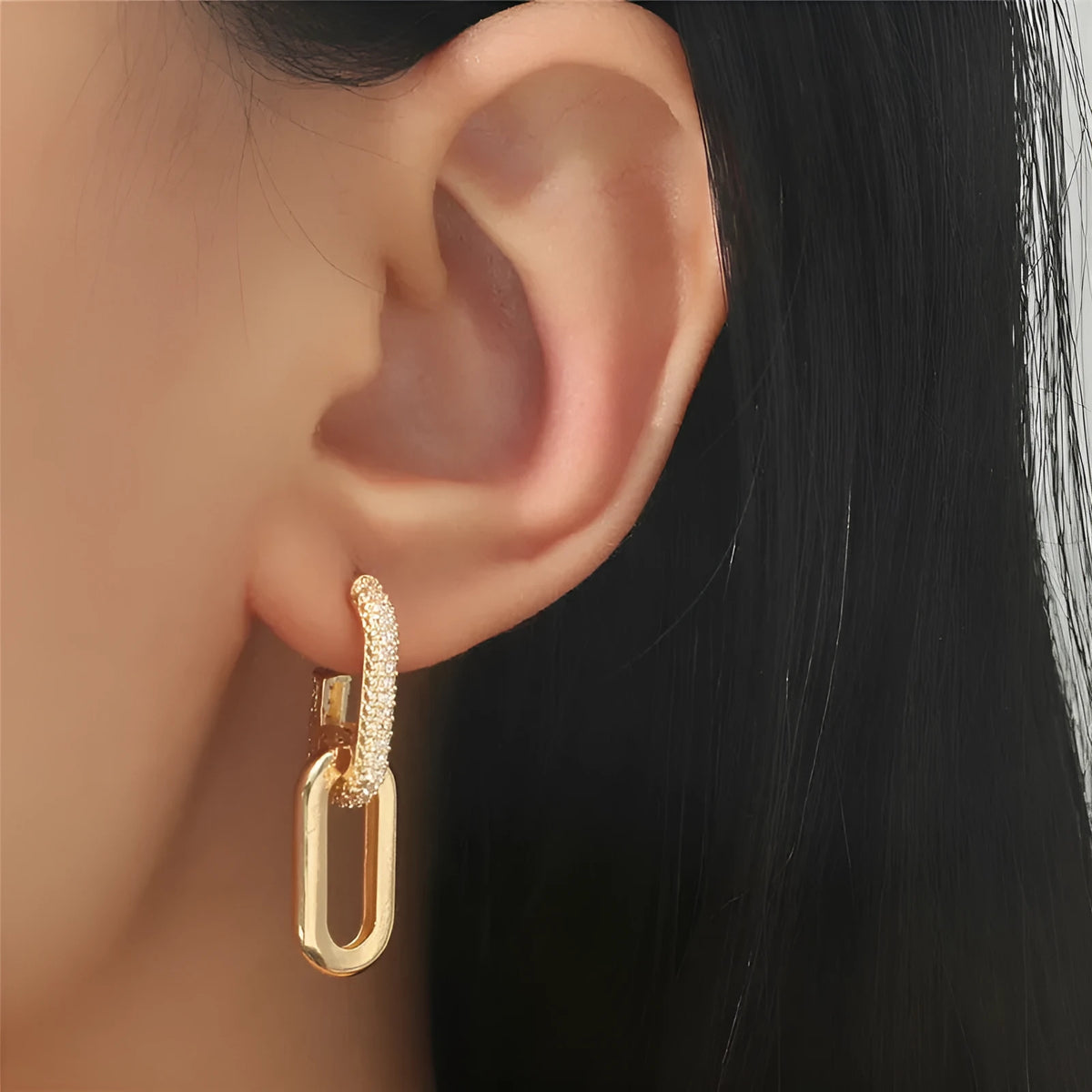 Pair of copper geometric ellipse earrings in 18K gold, silver, and rose gold finishes with diamond treatment