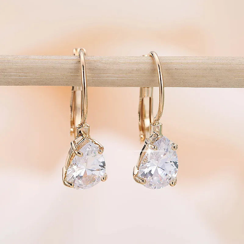Drop-shaped copper earrings with platinum inlaid gem, gold or platinum plating, approximately 2.5 cm long