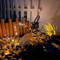 Solar-powered iron garden lamp with tapered butterfly design and warm white LED illumination