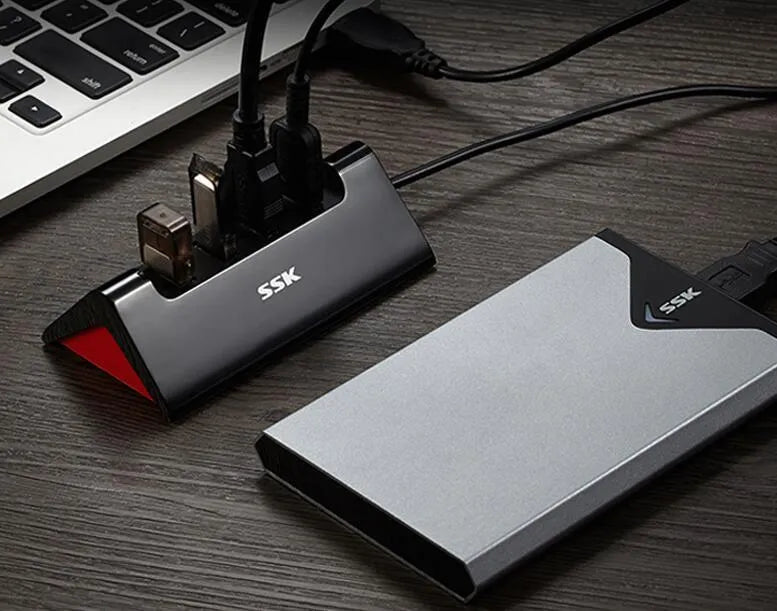 Black USB expansion dock with 4 ports and Micro USB power input on compact ABS plastic housing