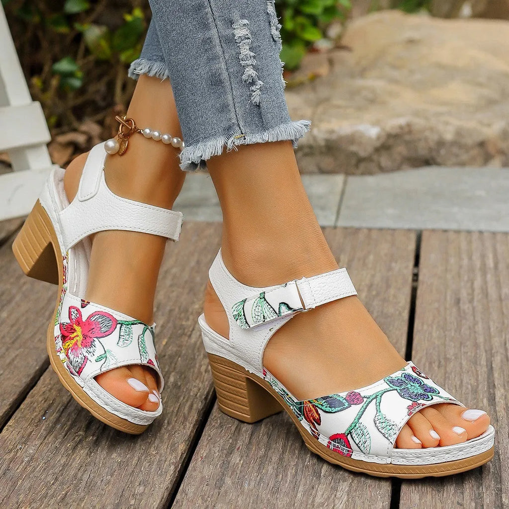 White women's high heel sandals showing velcro buckle fastening and rubber sole