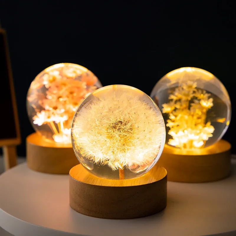 6cm diameter resin crystal ball with preserved dandelion flowers on beech wood stand, USB cable connected