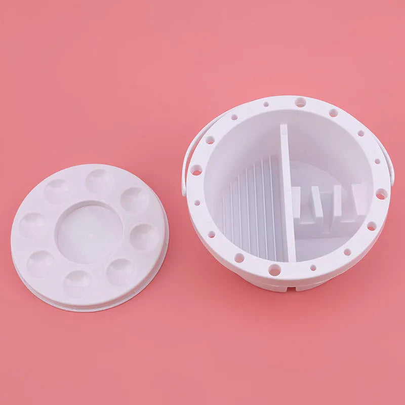 White plastic cylindrical brush holder with a side clip for painting.