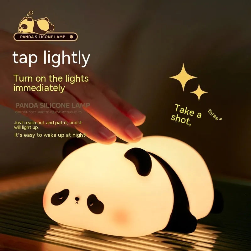 Panda-shaped night light with soft silicone surface, measuring 150x130x80mm, showing warm white glow