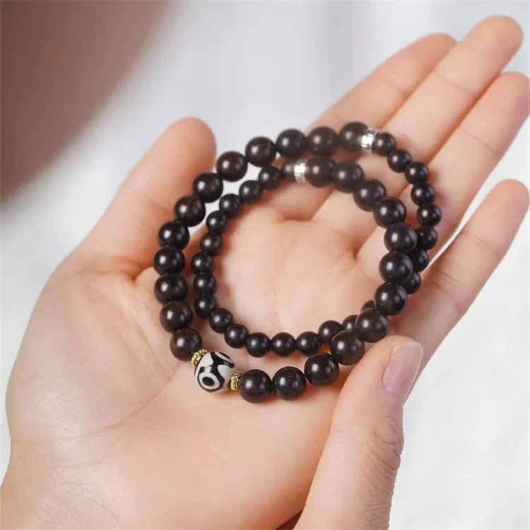 Solid ebony wood Tibetan bead bracelet with two circular 8mm beads on wrist