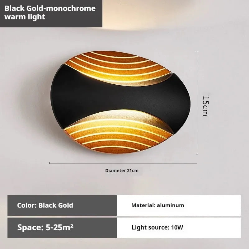 Modern minimalist aluminium wall lamp in black finish with LED light, mounted on a white wall.