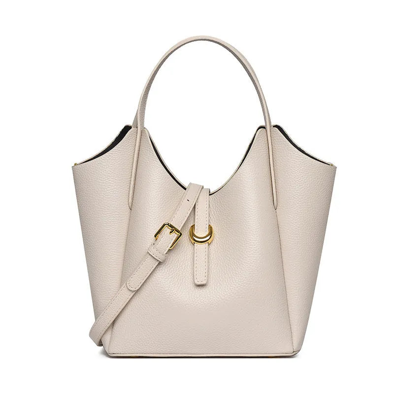 Genuine leather women's retro bucket handbag in beige with sewn detailing and an outer pocket.
