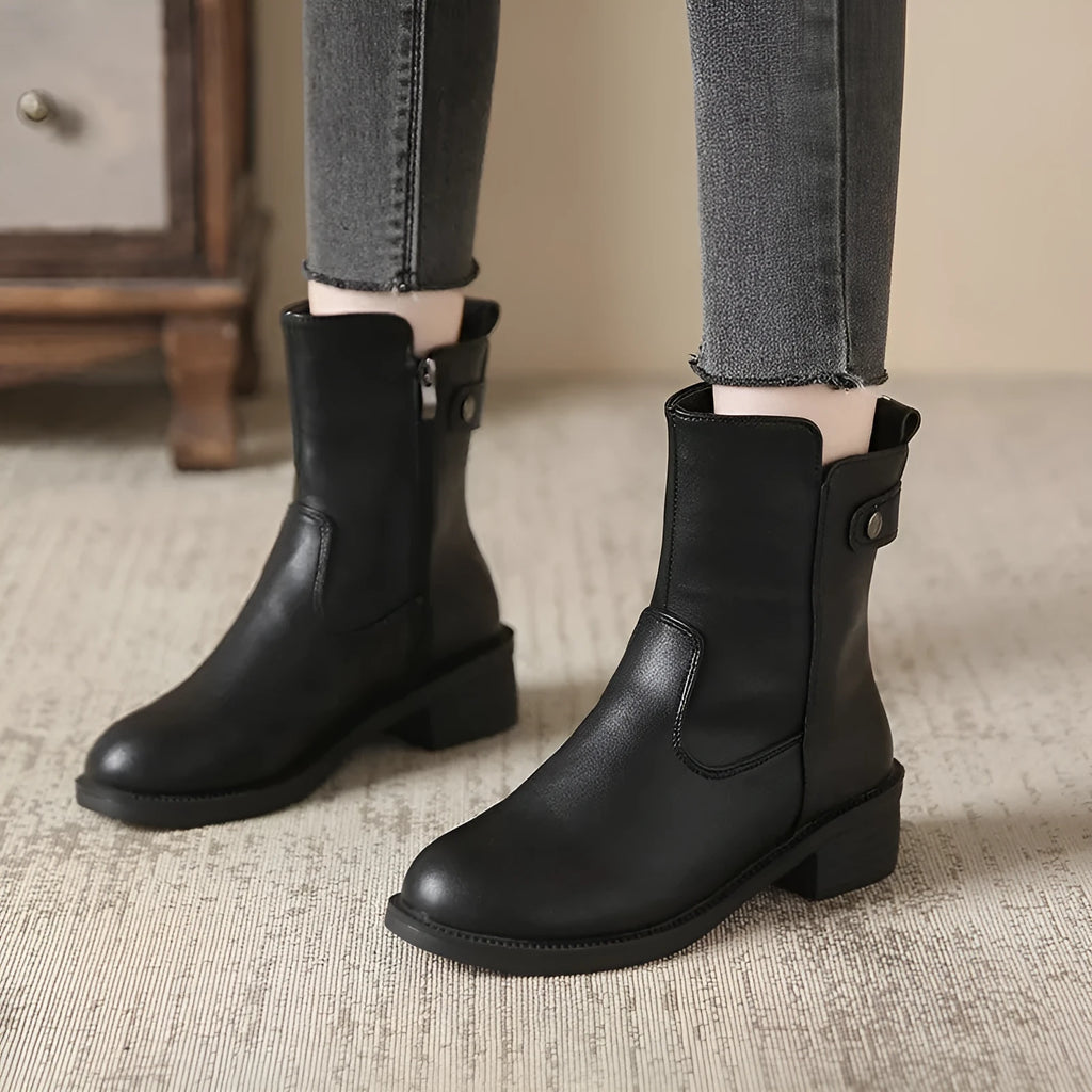 Black women's ankle boots with side zip, round toe, and a low rubber sole.