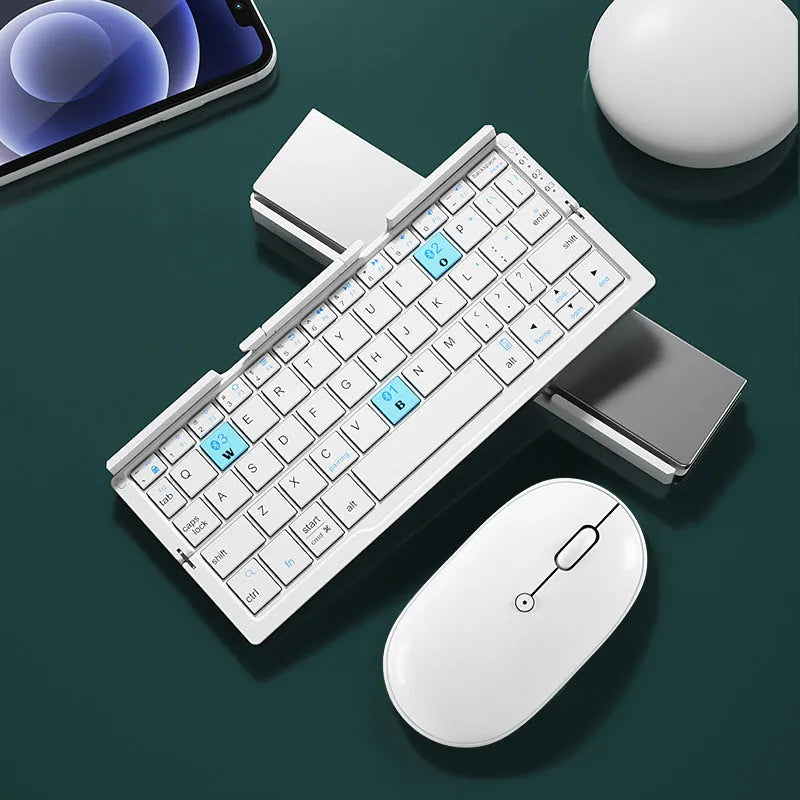 Silver white folding Bluetooth keyboard shown open with stand holding a smartphone, and folded next to a ruler for scale.