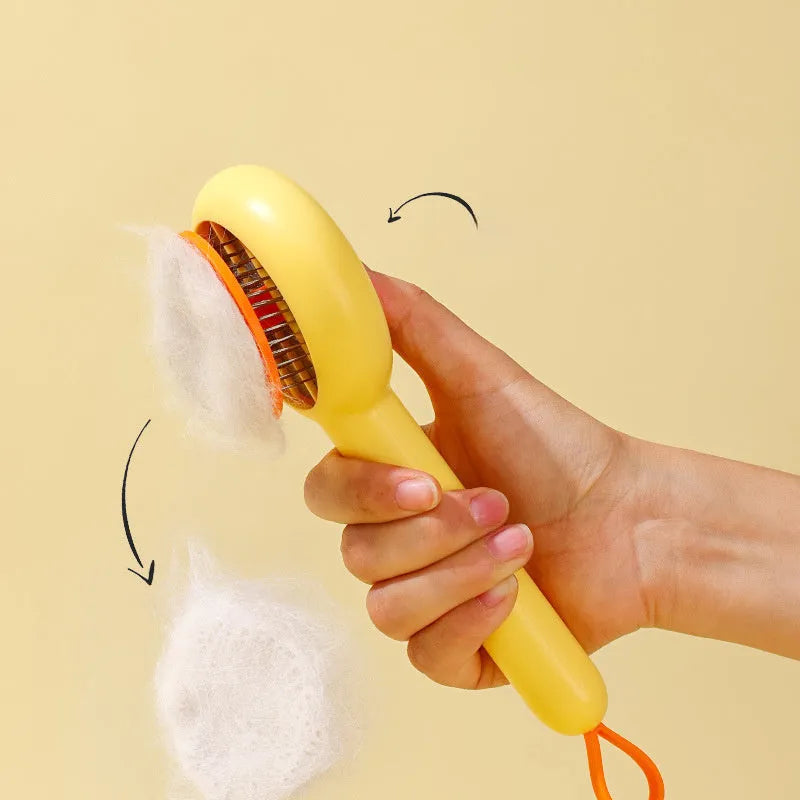Small yellow duck-shaped comb for pet grooming with open section and needle bristles