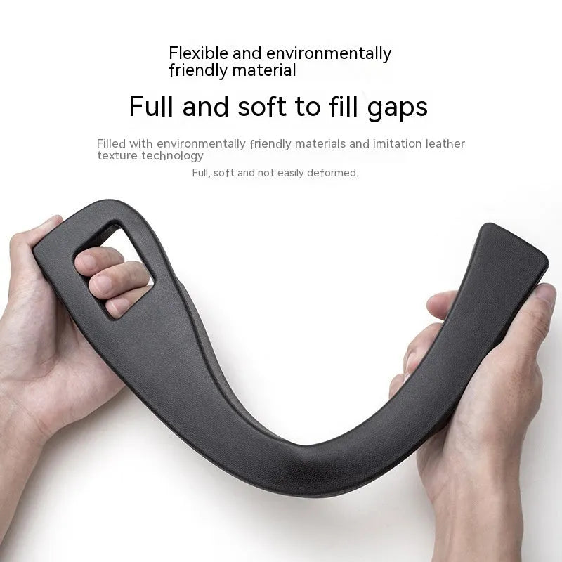 Black plastic storage box with handle placed in car seat gap.