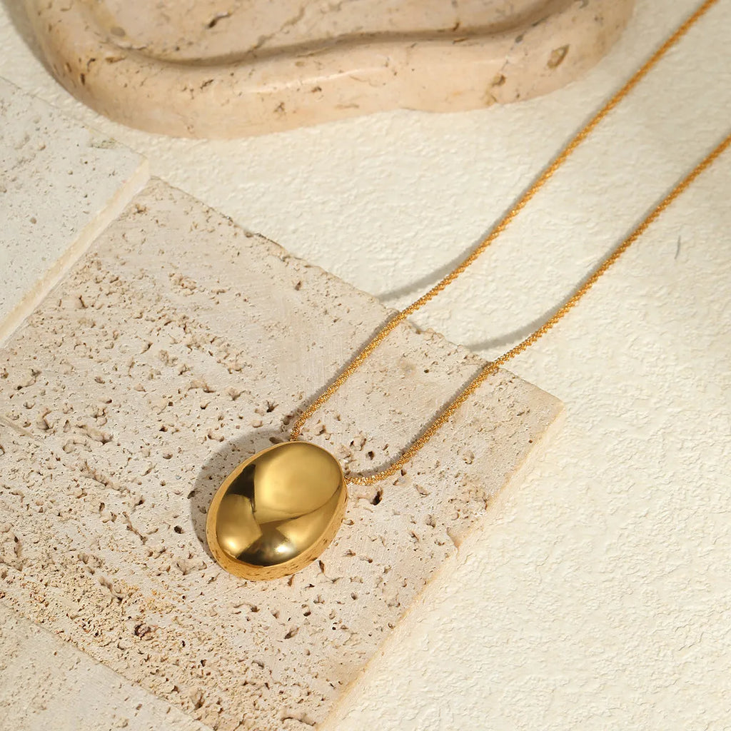 Long gold-plated necklace featuring a geometric pendant on an adjustable stainless steel chain.