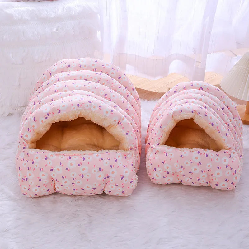 Closed cloth cat bed with removable cushion in a pink small flower pattern.