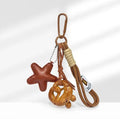 Handmade soda bread handbag pendant with baking varnish finish showing cartoon bread design and brown carrying strap