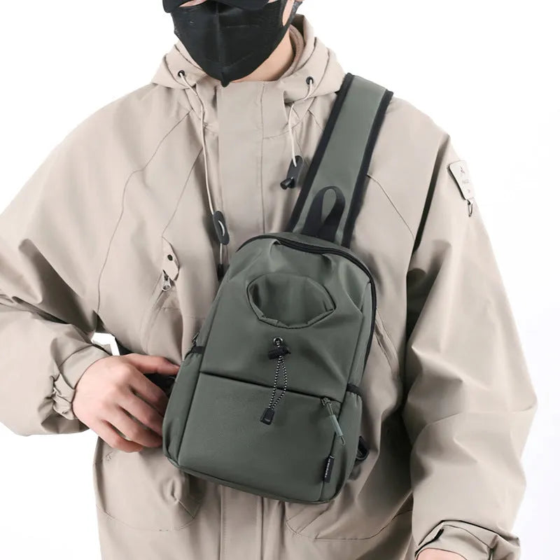 Dark grey Oxford cloth crossbody chest bag with stitching detail, shown being worn.