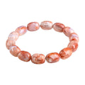 Natural cherry agate barrel shaped bead bracelet showing 10x14mm geometry design with Ruyi elements on wrist
