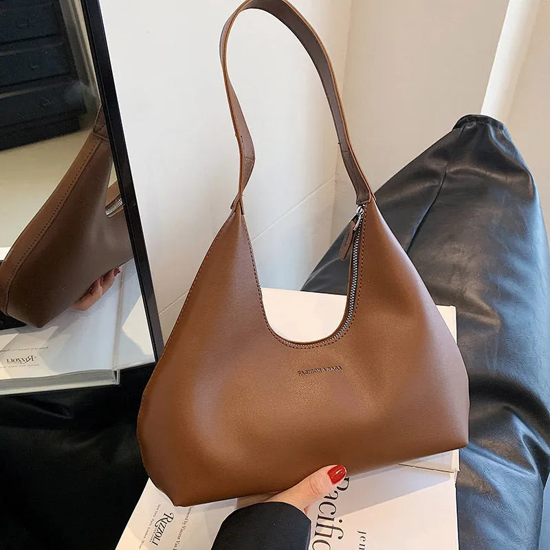 PU leather retro shoulder handbag in pillow shape with stitching details and single strap