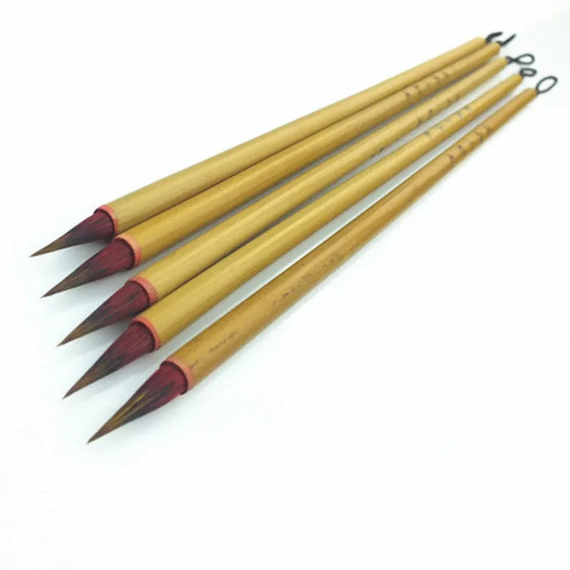 Small red-haired writing brush with a 23cm long handle on a flat surface.