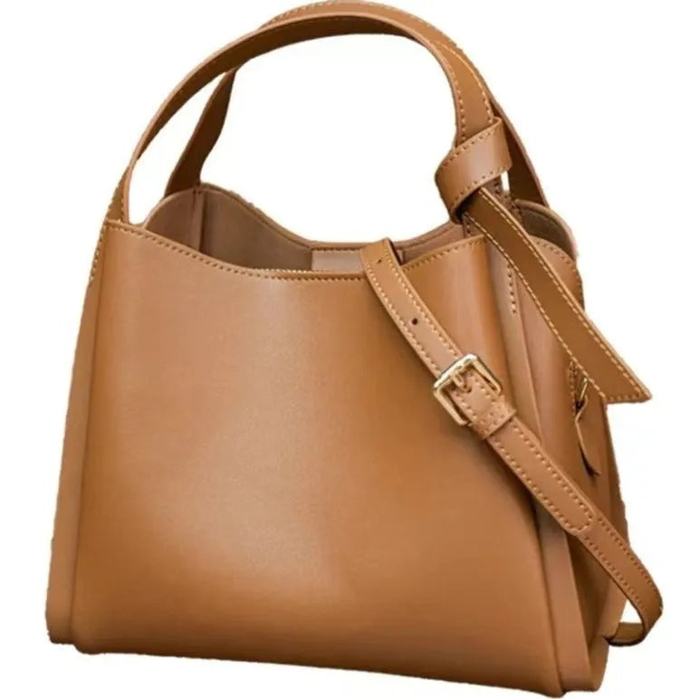 Women's tea brown genuine leather crossbody bucket bag showing internal zipped compartments