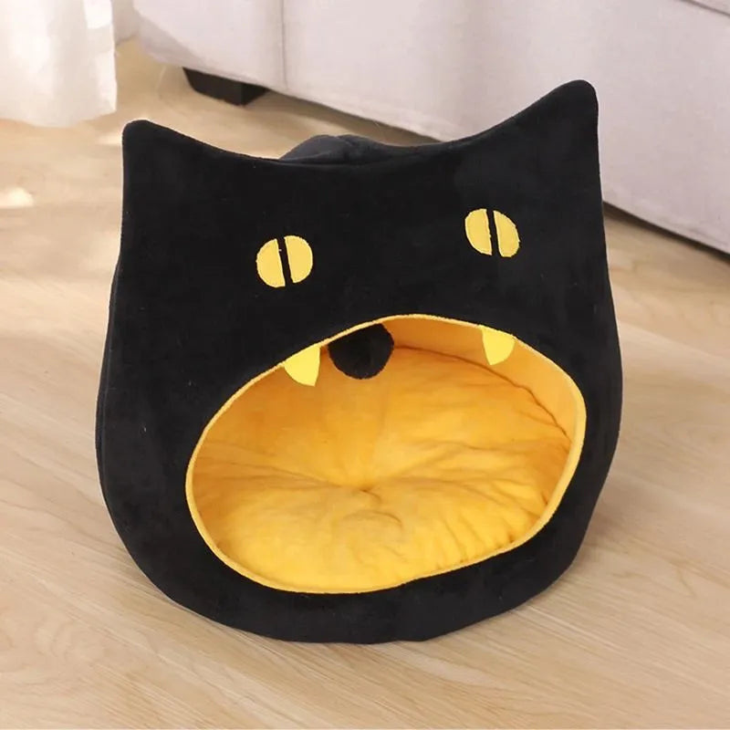 Grey covered cat cave pet bed with cat face design and anti-slip bottom.
