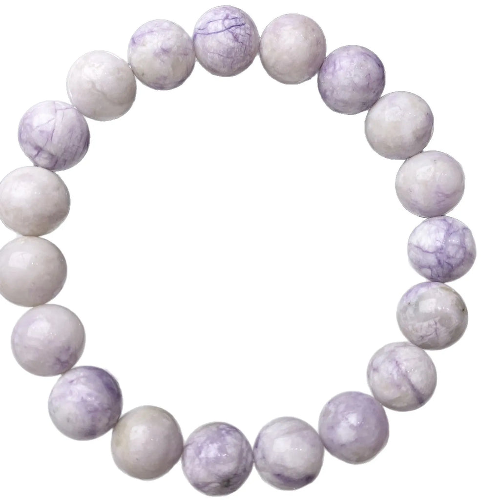 Natural purple turquoise bead bracelet for women on a white background, showing adjustable string tie.