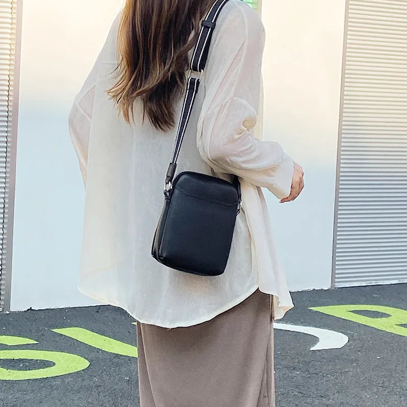 Solid colour mobile phone crossbody bag with adjustable strap, compact 14.5x5.5x19cm dimensions