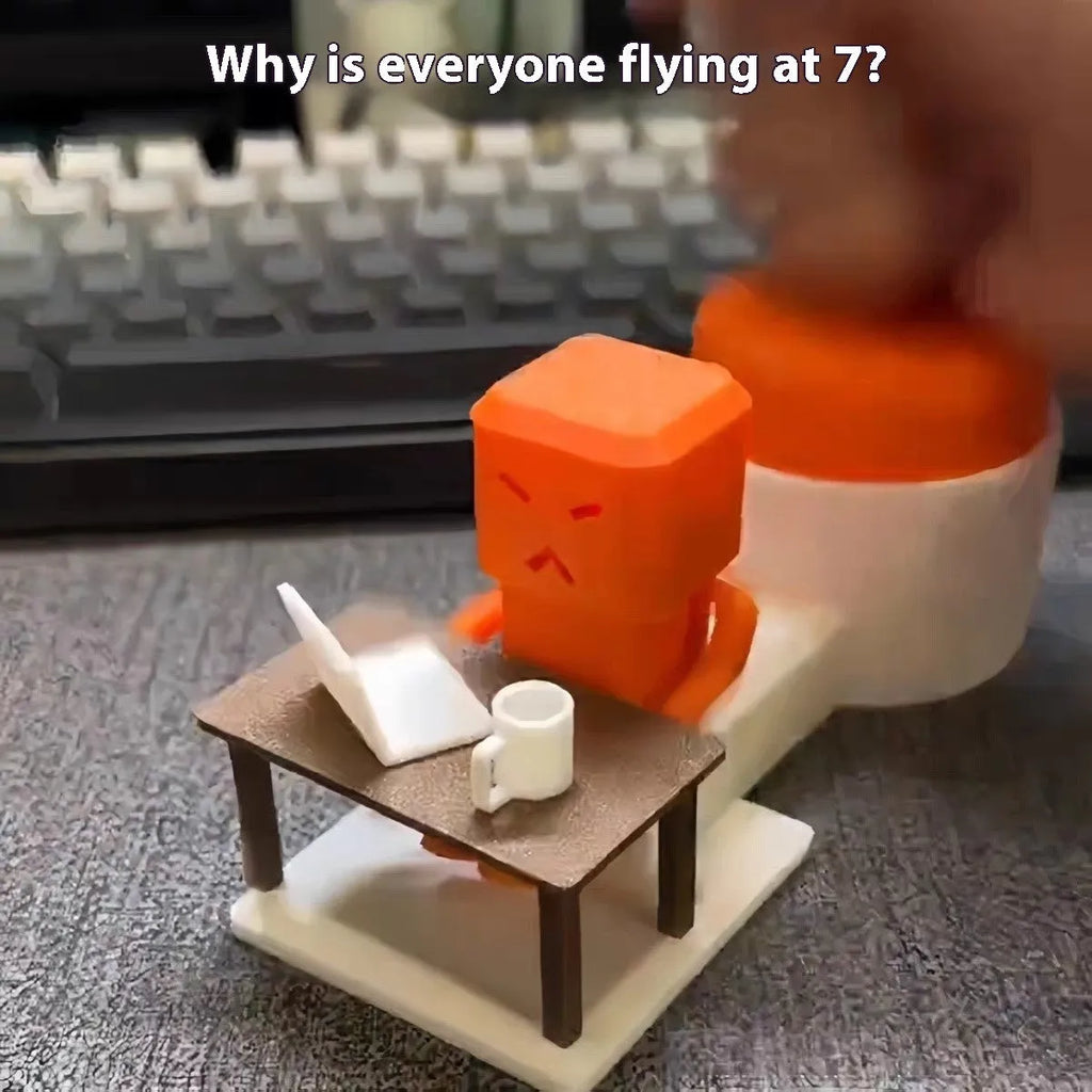 Orange plastic table-turning decompression toy measuring 16x6x7cm on wooden desk