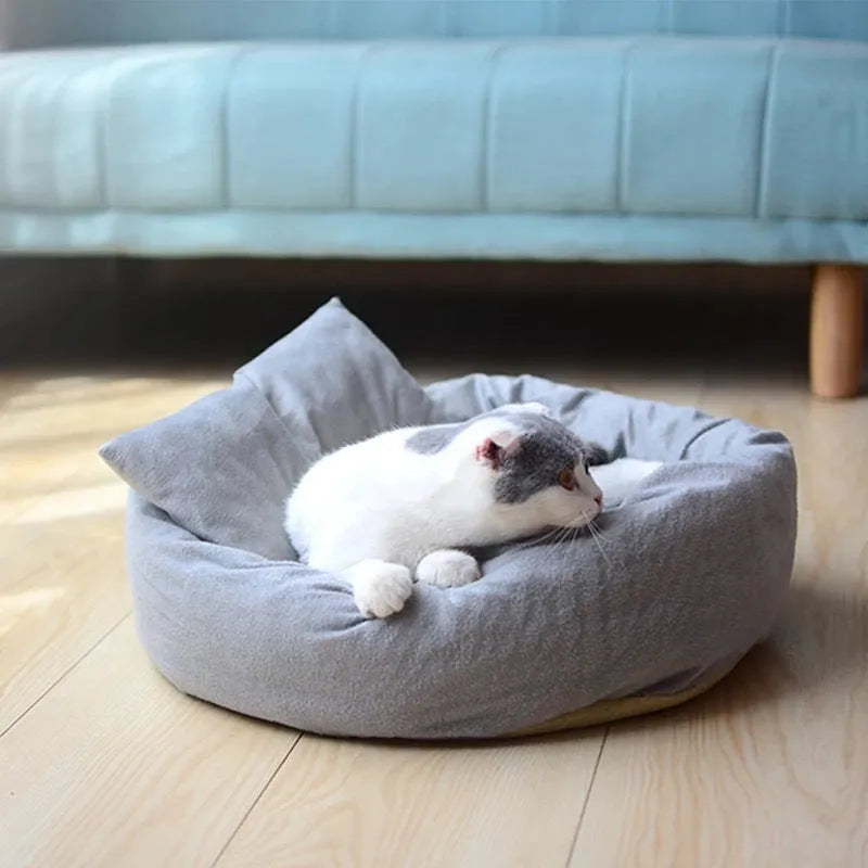 Grey round pet bed for small dogs and cats with raised edges and removable pillow on non-slip base
