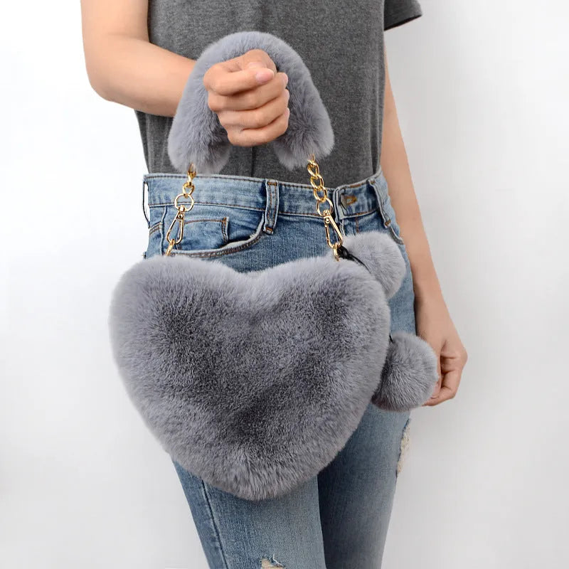Women's plush heart-shaped handbag with single adjustable strap in various solid colours