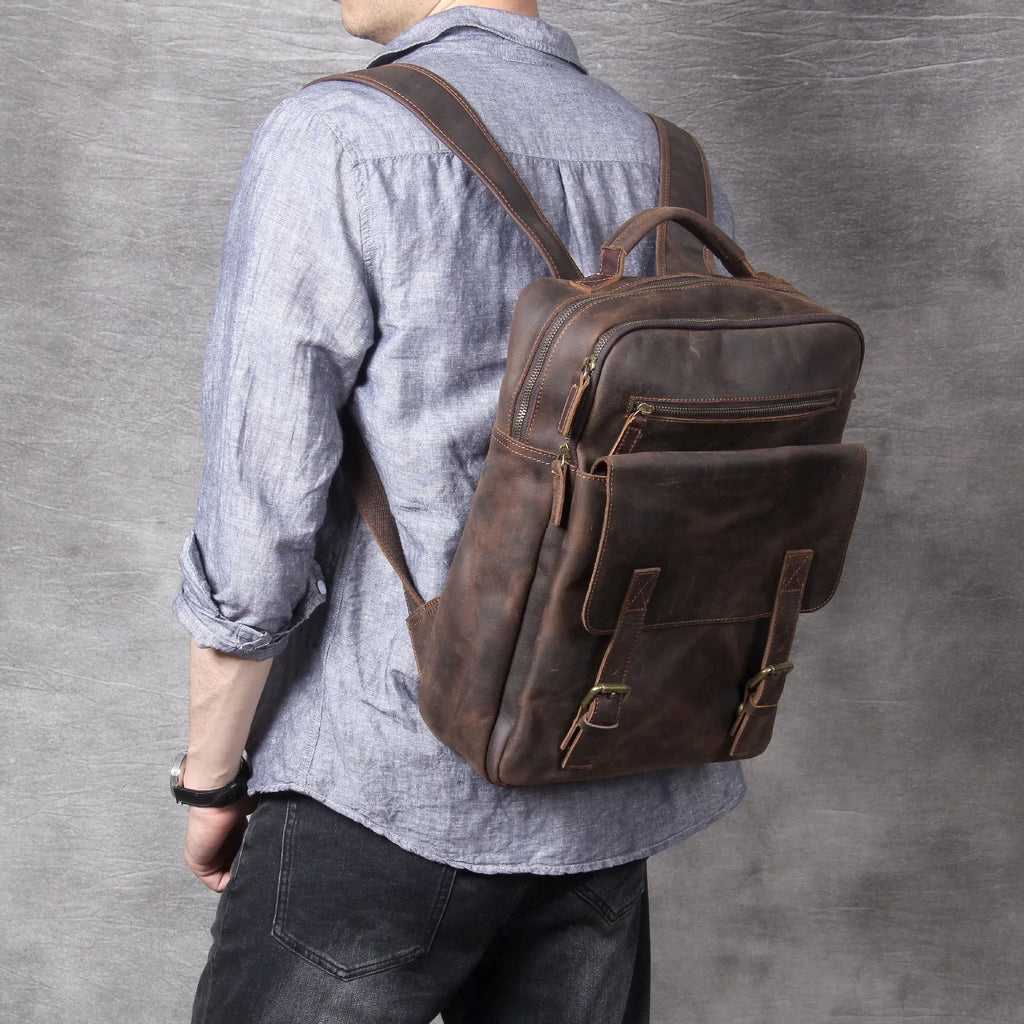 Dark coffee coloured handmade leather backpack with internal computer and mobile phone pockets.