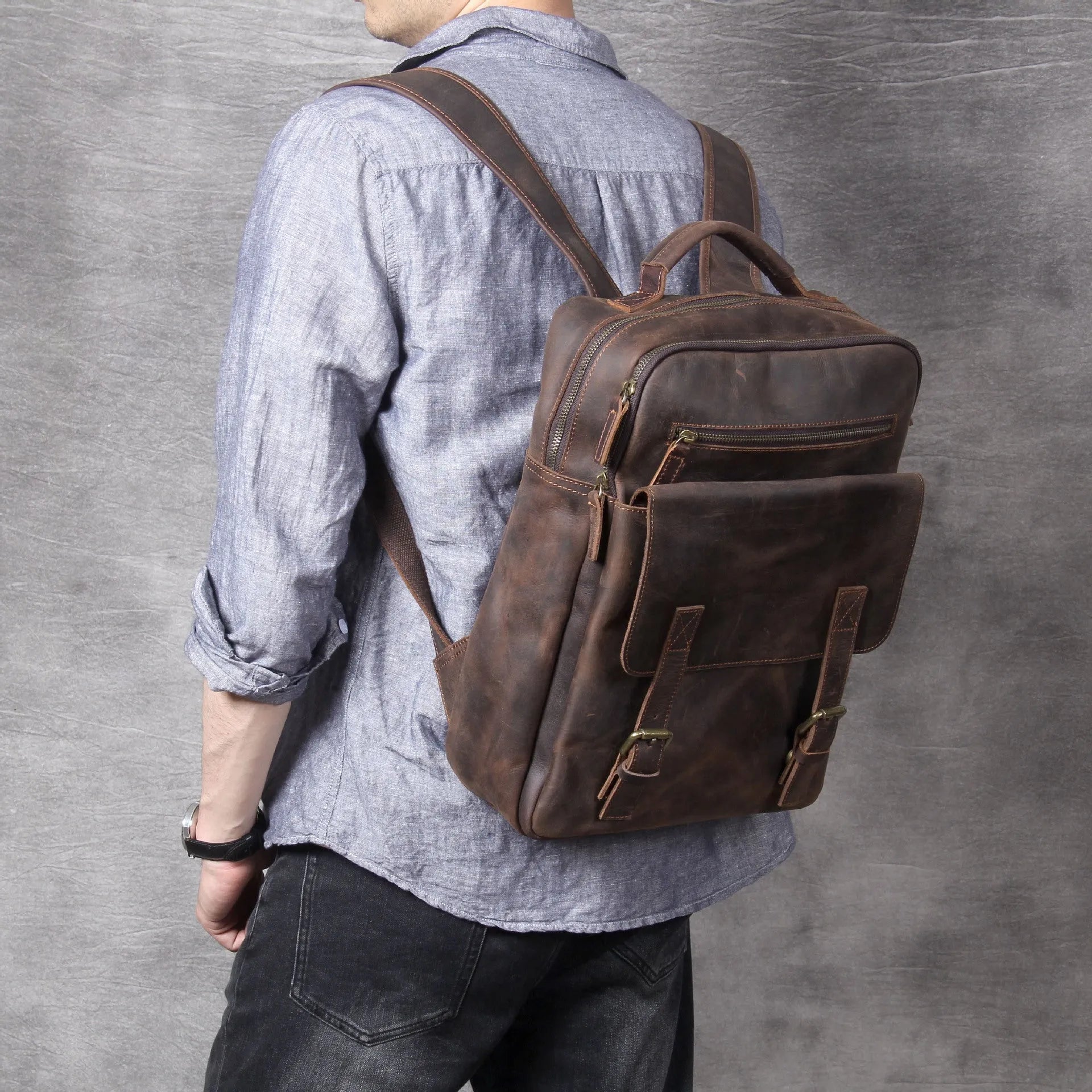 Dark coffee coloured handmade leather backpack with internal computer and mobile phone pockets.