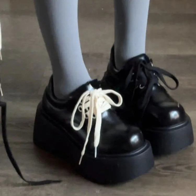 Women's matte black lace-up shoes with a 6-8cm English muffin heel and round toe on a solid background