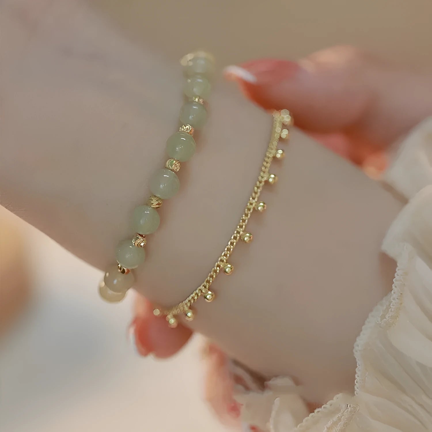 Natural Hetian Jade beaded bracelet with princess running motif on a wrist.