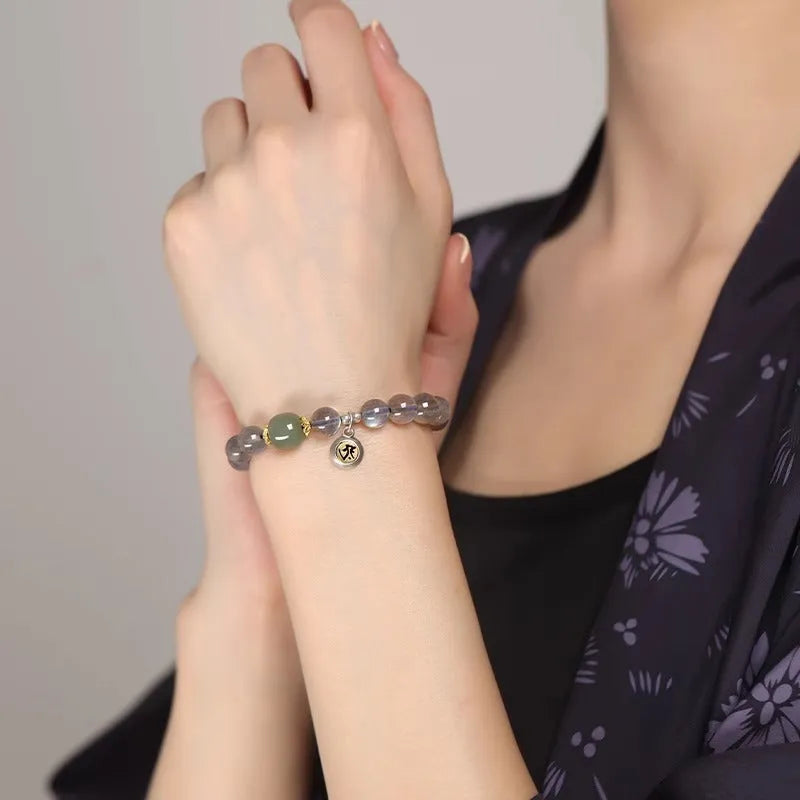 Women's bracelet with 8mm moonstone bead and electroplated Thousand-Hand Kwan-yin mouse charm.